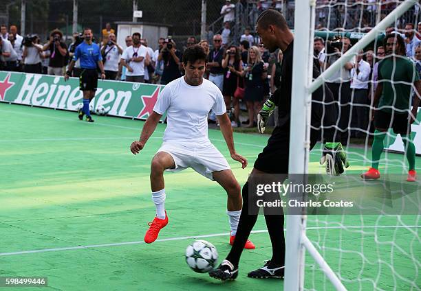 Dida passes the ball away from Sergio Perez of Mexico and Force India during the Heineken Champions of the Grid Charity football match during...