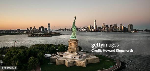 statue of liberty with nwc in background - new york harbour stock pictures, royalty-free photos & images