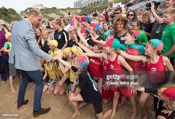 Prince William, Duke of Cambridge greets children as he visits the work of the Wave Project on Newquay's Towan Beach, an organisation that uses...