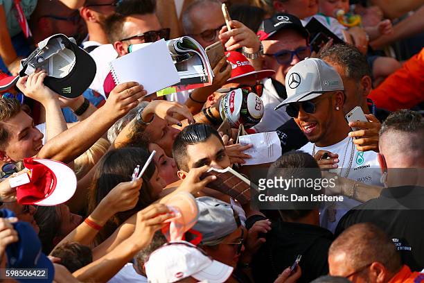 Lewis Hamilton of Great Britain and Mercedes GP takes a photo with fans during previews for the Formula One Grand Prix of Italy at Autodromo di Monza...