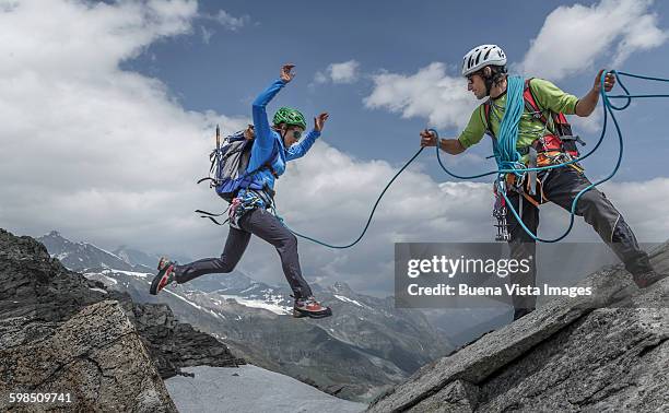 female climber jumping between rocks - rock climbing stock pictures, royalty-free photos & images