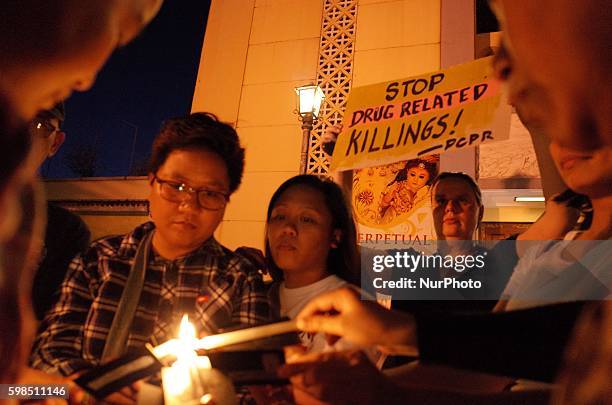 Filipino activists light candles for the victims of extrajudicial killings during a demonstration at the Sto. Domingo Church in Quezon City, east of...