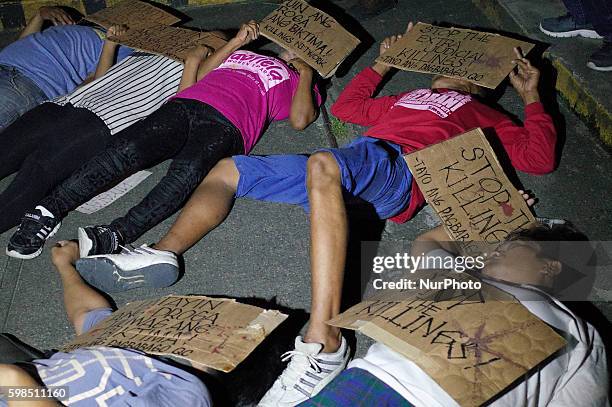 Filipino activists perform a &quot;die-in&quot; reminiscent of the victims of extrajudicial killings during a demonstration at the Sto. Domingo...