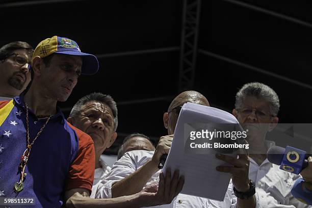 Jesus Torrealba, secretary-general of the opposition coalition, center, addresses supporters while Henrique Capriles, opposition leader and two-time...