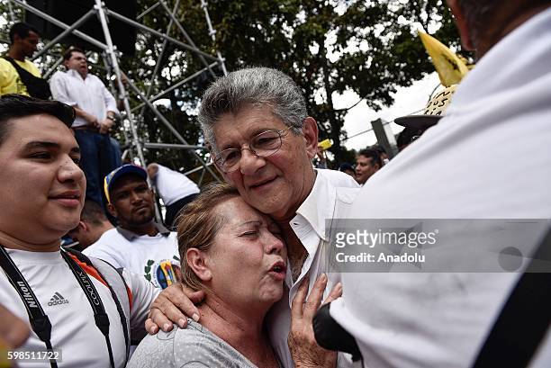 President of Venezuelan Congress Henry Ramos Allup embracing opposition supporter taking part in a march to demand to The National Election Council...