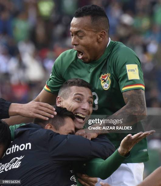 Bolivia's Pablo Escobar celebrates with Bolivia's defender Edemir Rodriguez after scoring against Peru during the Russia 2018 World Cup qualifier...