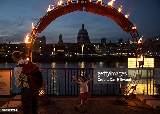Young girl dances beneath an installation in front of St Paul's Cathedral as part of the 'Fire Garden' event by Compagnie Carabosse on September 1,...