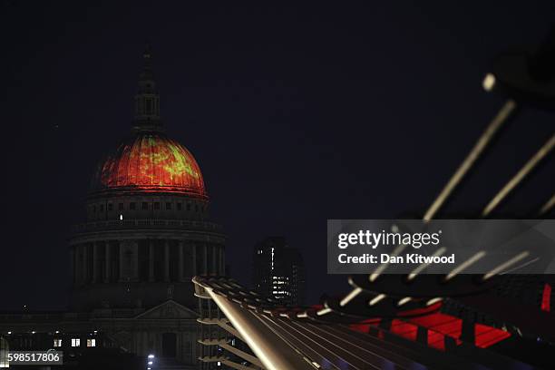 St Paul's Cathedral is illuminated as installations are lit in front of Tate Modern as part of the 'Fire Garden' event by Compagnie Carabosse on...