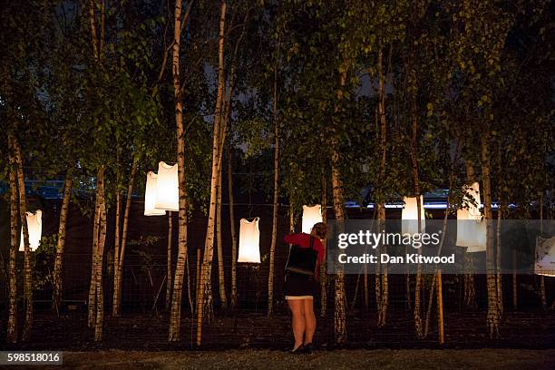 Visitor takes a photograph of an Installation in front of Tate Modern during the 'Fire Garden' event by Compagnie Carabosse on September 1, 2016 in...