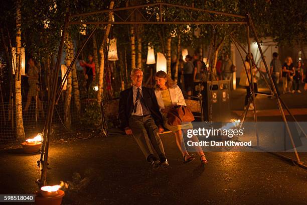 Couple enjoy a swing as installations are lit in front of Tate Modern as part of the 'Fire Garden' event by Compagnie Carabosse on September 1, 2016...