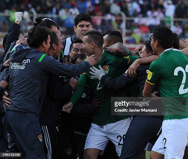 Pablo Escobar of Bolivia celebrates with his teammates after scoring the first goal of his team during a match between Bolivia and Peru as part of...