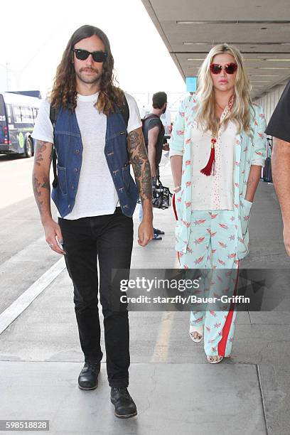 Kesha and Brad Ashenfelter are seen at LAX on September 01, 2016 in Los Angeles, California.