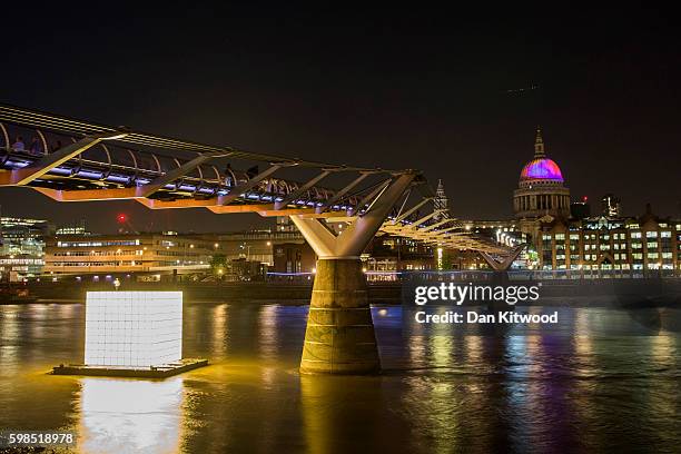St Paul's Cathedral is illuminated as installations are lit in front of Tate Modern as part of the 'Fire Garden' event by Compagnie Carabosse on...
