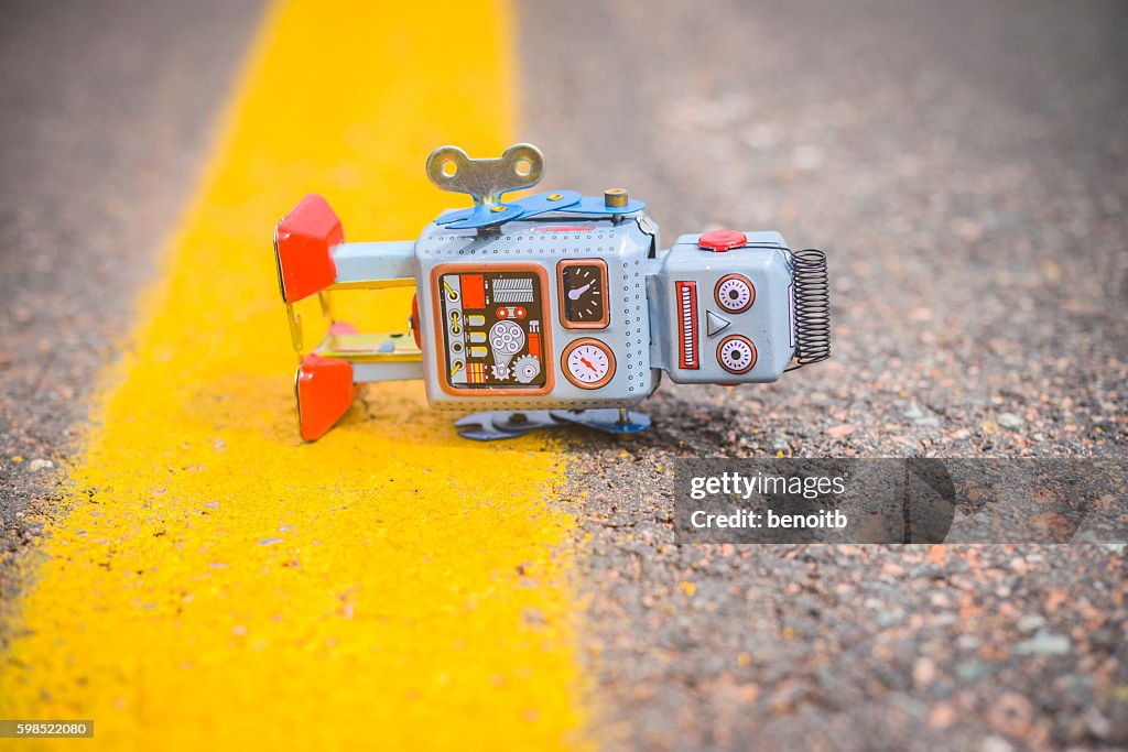 Retro robot fallen on the road