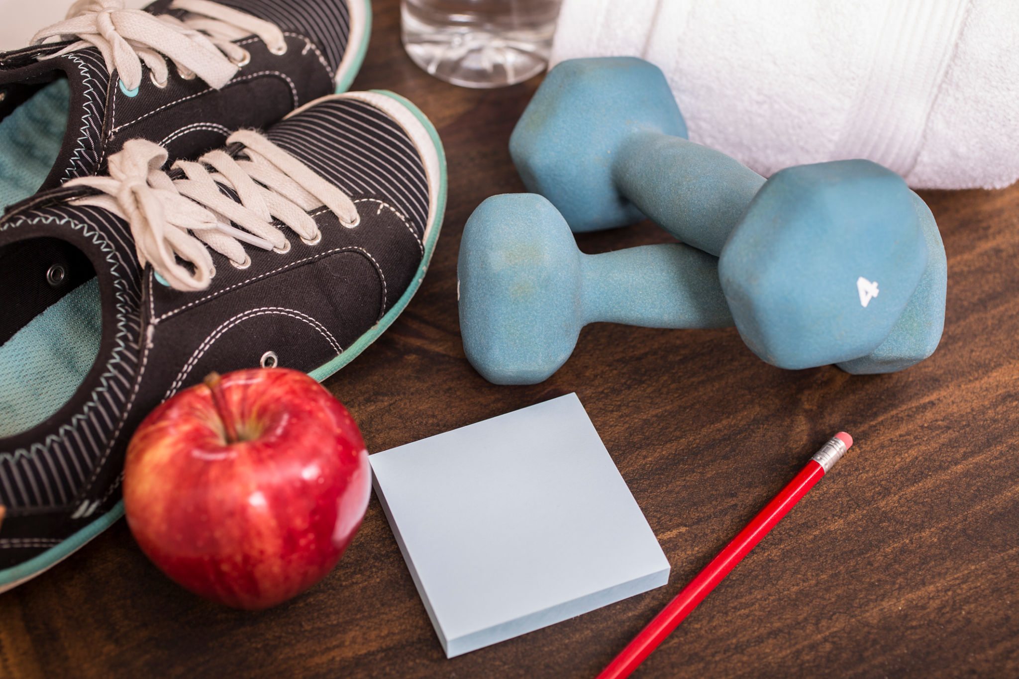 Fitness, exercise themed scene with weights, sneakers, apple. Fitness, exercise themed scene with weights, sneakers, apple.