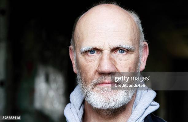 serious looking mature man - male blue eyes stock pictures, royalty-free photos & images