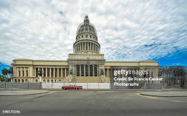 havana's capitol building with red vintage car and dramatic sky, cuba - kapitoleum bildbanksfoton och bilder