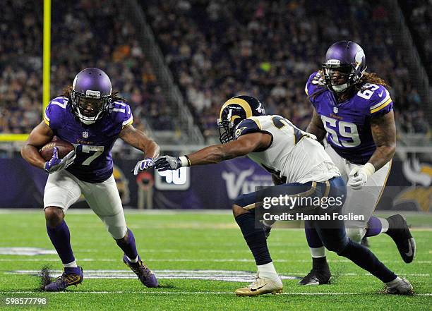 Jarius Wright of the Minnesota Vikings carries the ball against Christian Bryant of the Los Angeles Rams during the second quarter of the preseason...