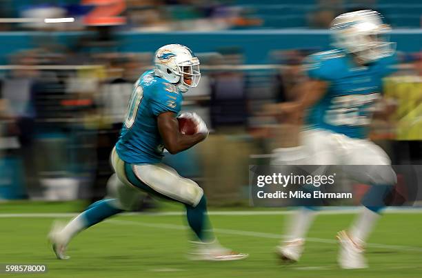Daniel Thomas of the Miami Dolphins rushes during a preseason game against the Tennessee Titans at Hard Rock Stadium on September 1, 2016 in Miami...