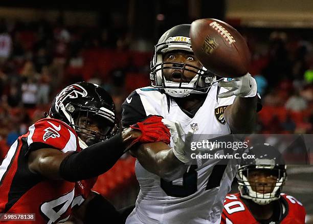 Neal Sterling of the Jacksonville Jaguars fails to pull in this reception against Damian Parms of the Atlanta Falcons at Georgia Dome on September 1,...