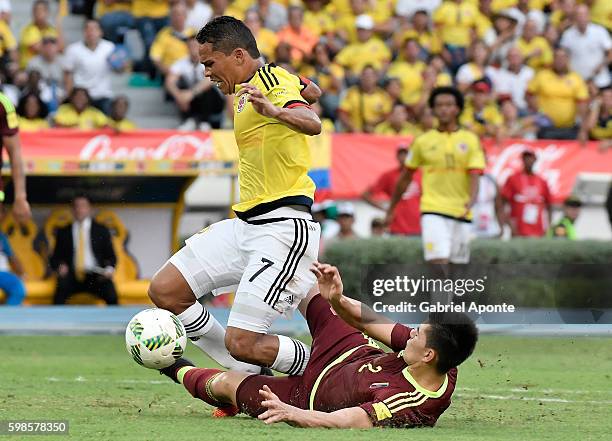 Wilker Angel of Venezuela makes a penalty foul over Carlos Bacca of Colombia during a match between Colombia and Venezuela as part of FIFA 2018 World...