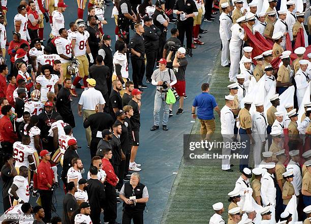 Colin Kaepernick of the San Francisco 49ers on the sidelines as military personel line up before the singing of the National Anthem before a...