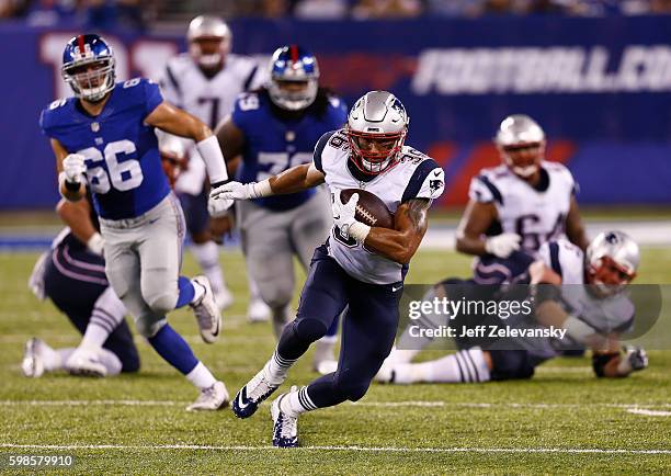 Tyler Gaffney of the New England Patriots runs the ball against the New York Giants during a preseason game at MetLife Stadium on September 1, 2016...