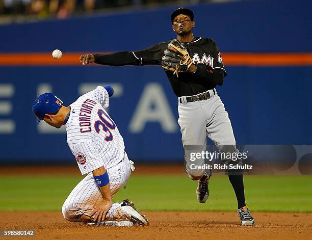 Dee Gordon of the Miami Marlins gets the force out on Michael Conforto of the New York Mets and throws to first base to get James Loney for a double...