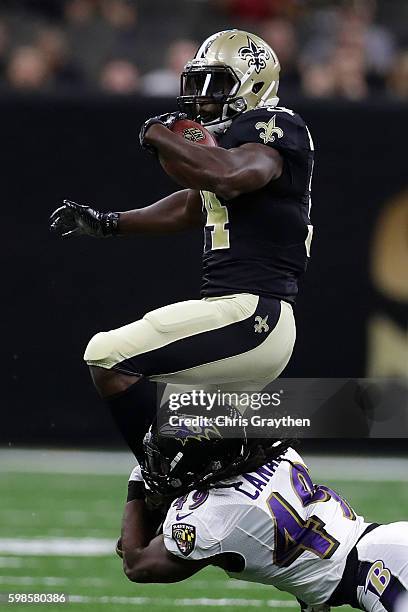 Tim Hightower of the New Orleans Saints is tackled by Kyle Juszczyk of the Baltimore Ravens at the Mercedes-Benz Superdome on September 1, 2016 in...