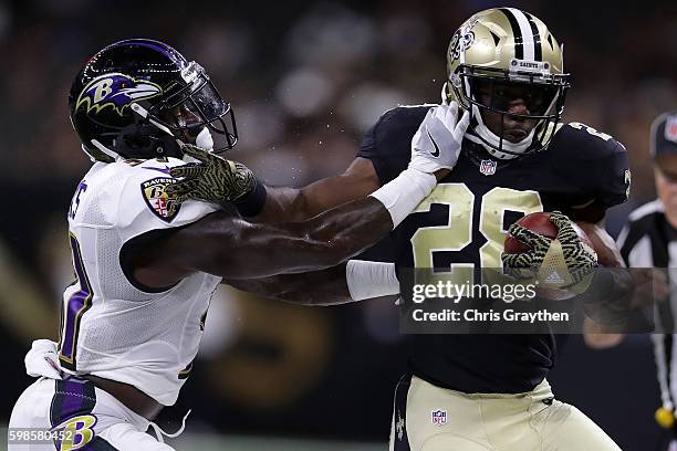 Spiller of the New Orleans Saints is tackled by Terrence Brooks of the Baltimore Ravens at the Mercedes-Benz Superdome on September 1, 2016 in New...