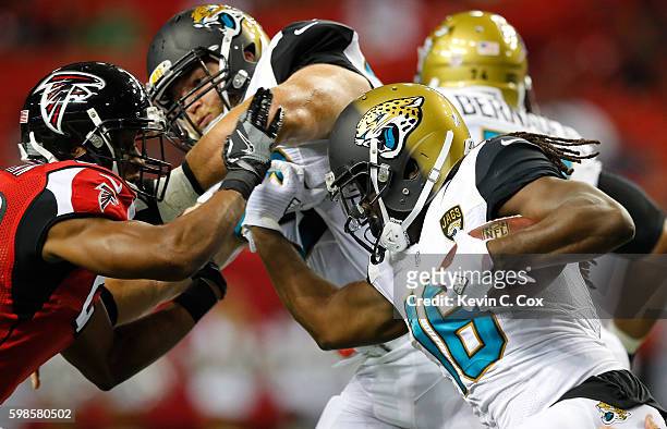 Denard Robinson of the Jacksonville Jaguars rushes against Desmond Trufant of the Atlanta Falcons at Georgia Dome on September 1, 2016 in Atlanta,...