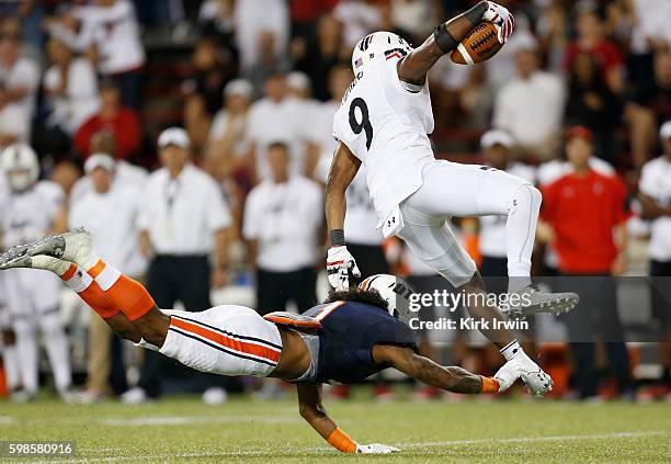 Najee Ray of the Tennessee-Martin Skyhawks tackels Linden Stephens of the Cincinnati Bearcats after intercepting a pass during the fourth quarter at...