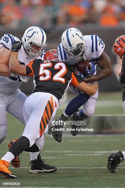 Stevan Ridley of the Indianapolis Colts runs the football upfield against Trevor Roach of the Cincinnati Bengals at Paul Brown Stadium on September...
