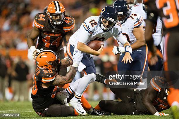 Inside linebacker Scooby Wright of the Cleveland Browns sacks quarterback David Fales of the Chicago Bears during the third quarter during a...
