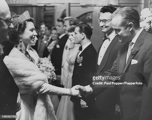 Queen Elizabeth II shaking hands with American entertainer Bob Hope after watching the Royal Variety Performance at the London Palladium, November...