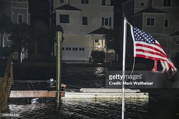 People come out to inspect the damage as the eye of Hurricane Hermine passes overhead in the early morning hours on September 2, 2016 in Shell Point...