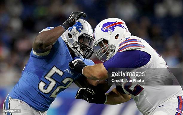 Detroit Lions linebacker Antwione Williams goes up against Buffalo Bills guard Ryan Groy during the first half of an NFL football game in Detroit,...