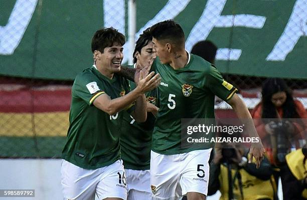 Bolivia's defender Ronald Raldes celebrates with Bolivia's defender Nelson Cabrera after scoring against Peru during the FIFA World Cup 2018...