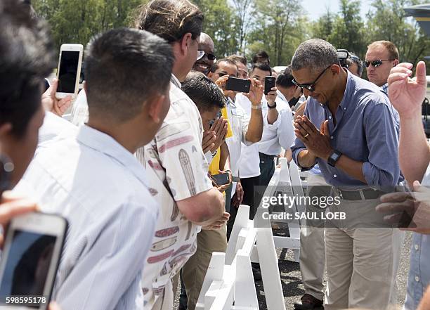 President Barack Obama greets some of the residents of the island during a tour of Midway Atoll in the Papahanaumokuakea Marine National Monument in...