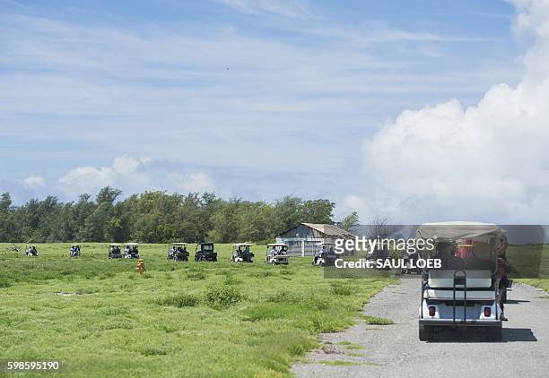Motorcade of golf carts drives US President Barack Obama around the island as he tours Midway Atoll in the Papahanaumokuakea Marine National Monument...