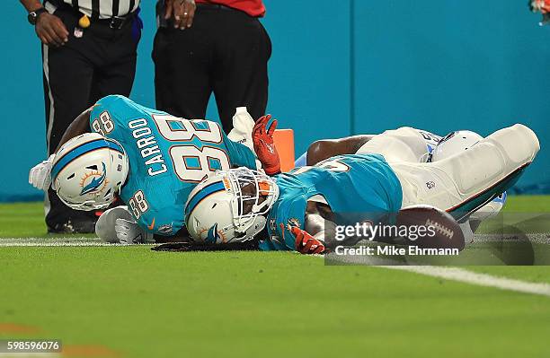 MarQueis Gray of the Miami Dolphins is tacken down at the goal line during a preseason game against the Tennessee Titans at Hard Rock Stadium on...