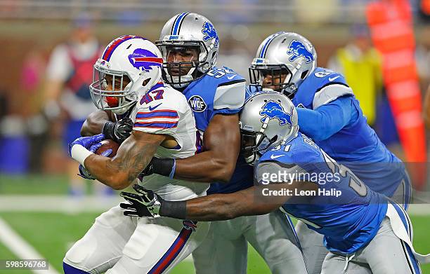 Dan Herron of the y the Detroit Lions defense lead by Antwione Williams during the first quarter of the game at Ford Field on September 1, 2016 in...