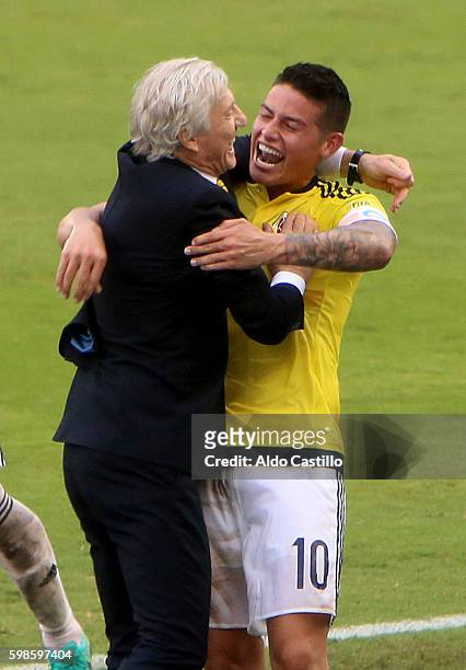 James Rodriguez celebrates with coach Jose Pekerman after scoring the opening goal during a match between Colombia and Venezuela as part of FIFA 2018...