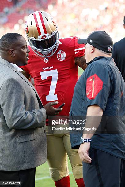 An NFL official talks with Colin Kaepernick and Head Coach Chip Kelly of the San Francisco 49ers on the field prior to the game against the Green Bay...