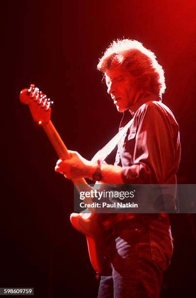 American Rock musician John Fogerty plays guitar as he performs onstage, Philadelphia, Pennsylvania, September 6, 1986.