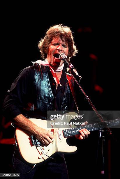 American Rock musician John Fogerty plays guitar as he performs onstage at the Poplar Creek Music Theater, Hoffman Estates, Illinois, September 25,...