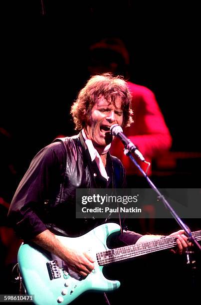 American Rock musician John Fogerty plays guitar as he performs onstage at the Poplar Creek Music Theater, Hoffman Estates, Illinois, September 25,...