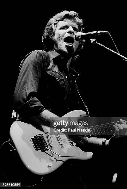 American Rock musician John Fogerty plays guitar as he performs onstage, Philadelphia, Pennsylvania, September 6, 1986.