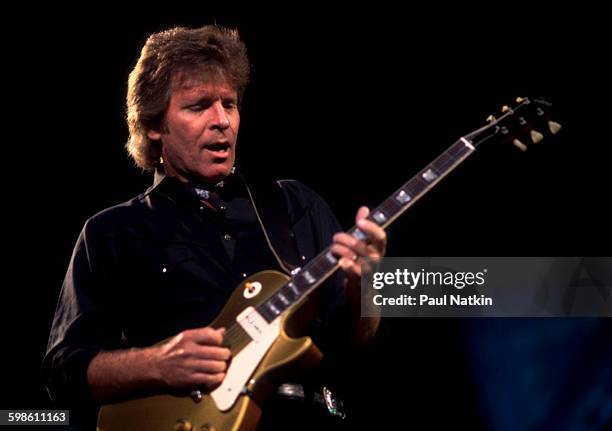 American Rock musician John Fogerty plays guitar as he performs onstage during the Farm Aid benefit concert at the World Music Theater, Tinley Park,...