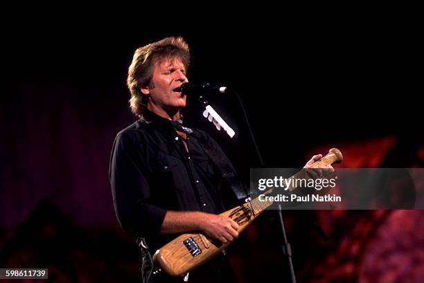 American Rock musician John Fogerty plays guitar as he performs onstage during the Farm Aid benefit concert at the World Music Theater, Tinley Park,...